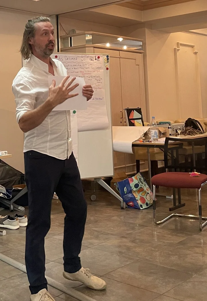 Matthias facilitating a workshop beside a flipchart
